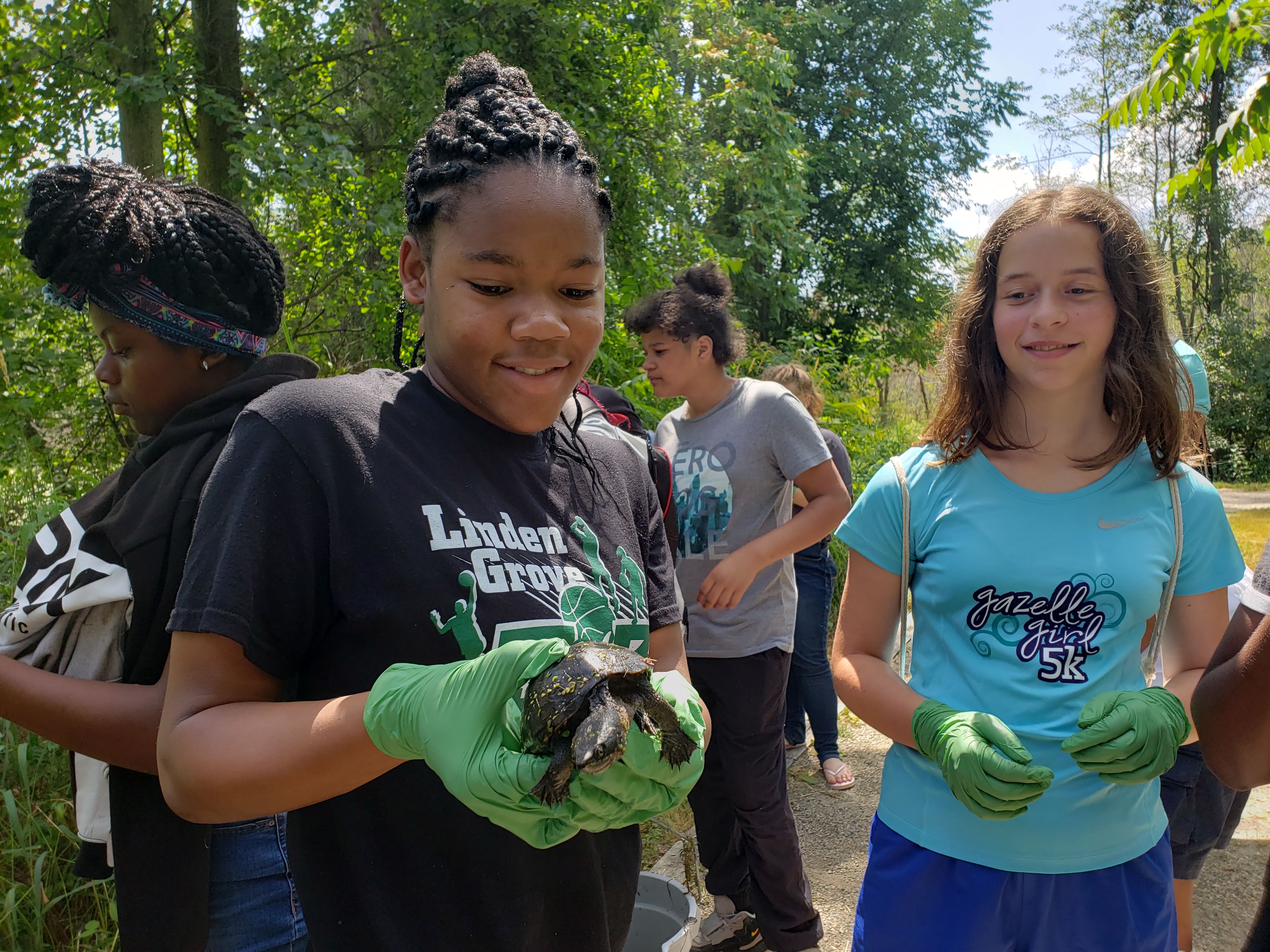 Students holding a turtle.