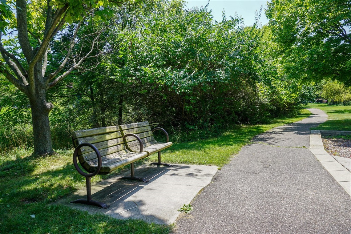 Benches and the walking trail at Axtell Creek Park